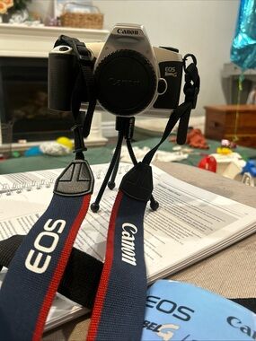 Canon EOS Rebel G Silver and Black Film SLR with Blue and Red Canon Strap